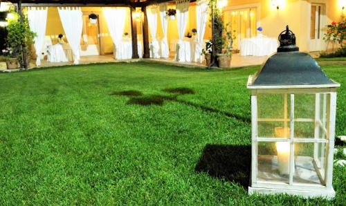 a lantern sitting on the grass in a yard at Semiramide Palace Hotel in Castellana Grotte