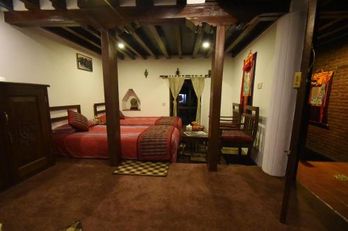 a bedroom with a bed and a table and a chair at Temple House in Kathmandu
