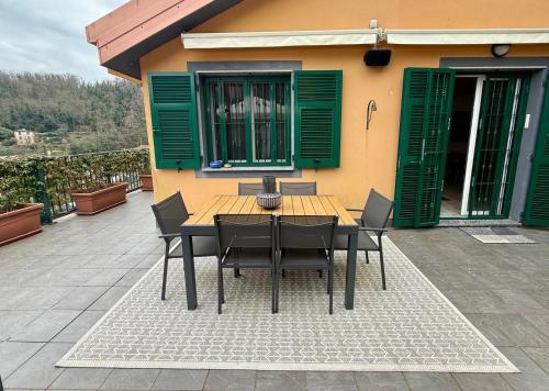 a wooden table and chairs on a patio at Villa Goga in Ruta