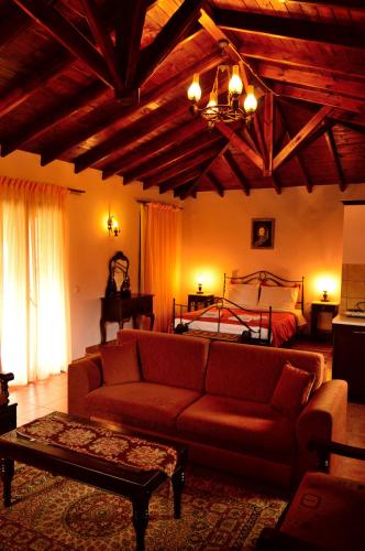 a living room with a couch and a bed at Guesthouse Rodamos in Taxiarchis