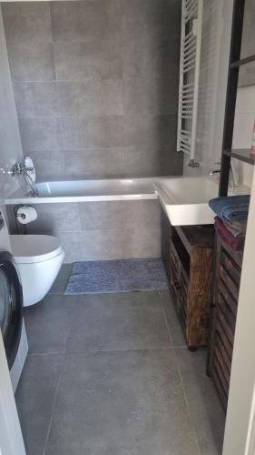 a bathroom with a tub and a toilet and a sink at 3-room apartment in Trnava