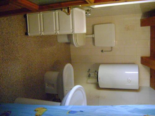 a bathroom with a toilet and a paper dispenser at La Maison Nouva 1977 in Aosta