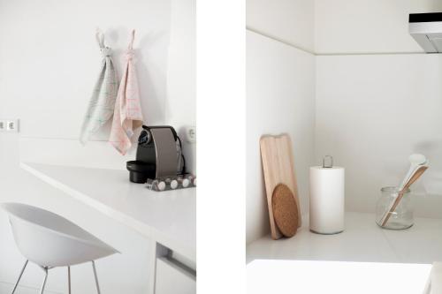 a bathroom with a white counter and a white chair at 60 Balconies Art in Madrid