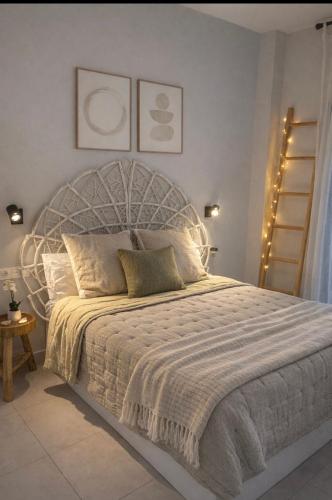 a bedroom with a large bed with lights on it at NUEVO-LUZ DE CONIL piscina y parking in Conil de la Frontera