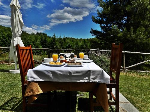 a table with food and drinks on top of it at Guesthouse Rodamos in Taxiarchis