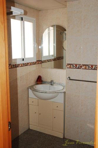 a bathroom with a sink and a mirror at Hostal Mary Tere in Salobreña