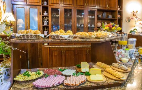 a buffet filled with lots of different types of food at Hotel Azaleia in Gramado