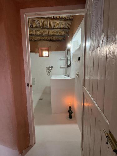 a bathroom with a sink and a toilet in a room at Tigmi Hamid Découverte des traditions et de la culture berbère in Aït Benhaddou