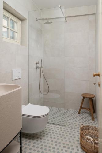 a bathroom with a shower and a toilet and a sink at Casa Sorelle secluded villa with breathtaking pool in Seline