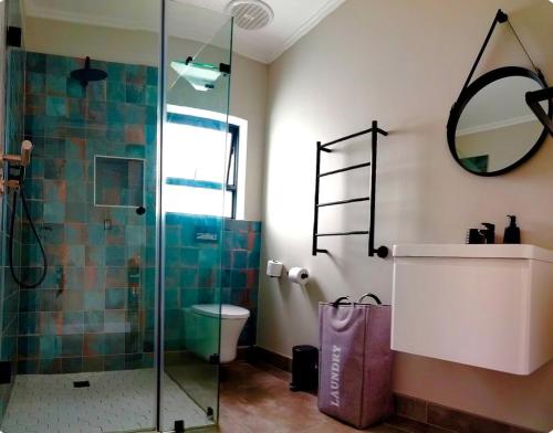 a bathroom with a glass shower and a toilet at Number 1 at SuPaViews in Wilderness