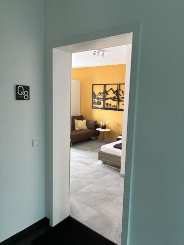 a living room with a couch and a mirror at Quartier 8 - Ein-Zimmer-Apartment in Geisenfeld