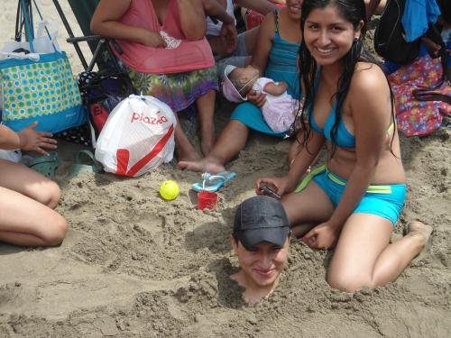 a group of women sitting in the sand at Cruz del Sur in Pucusana