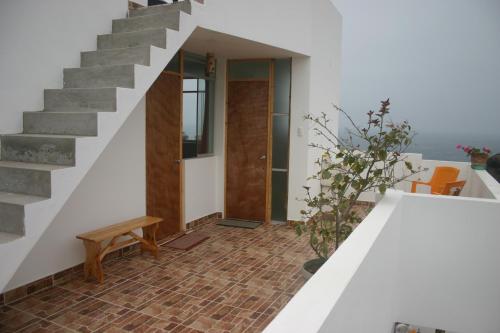a staircase leading up to a home with a stair case at Cruz del Sur in Pucusana