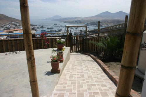 a balcony with potted plants and a view of a harbor at Cruz del Sur in Pucusana