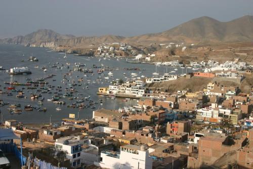 a city with a harbor with boats in the water at Cruz del Sur in Pucusana