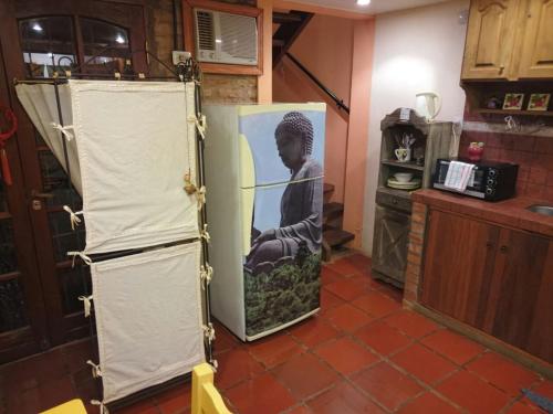 a refrigerator with a picture of a child on the door at Casa 24 Puerto Iguazu in Puerto Iguazú