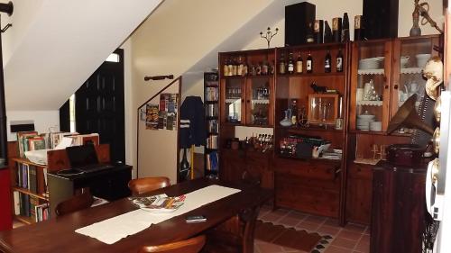 a dining room with a table and a book shelf at B&B I Tre Nuraghi in Macomer