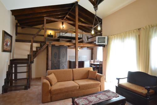 a living room with a couch and a loft bed at Guesthouse Rodamos in Taxiarchis