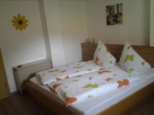a bedroom with a bed with flowers on it at Haus Hinterstererhof in Saalbach Hinterglemm