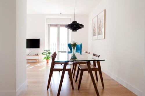 a dining room with a table and chairs at 60 Balconies Art in Madrid