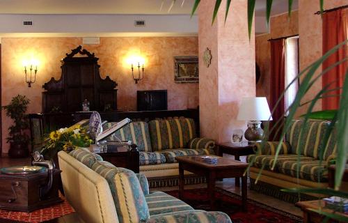 a living room with couches and a table at Hotel Villa Sonia in Taormina