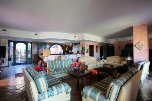 a living room with couches and a table at Hotel Villa Sonia in Taormina