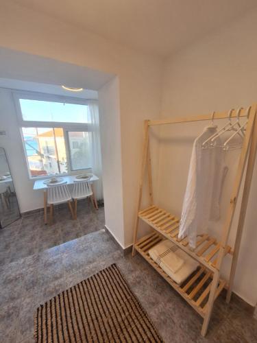 a room with a closet with a table and a window at Perla in Pythagoreio