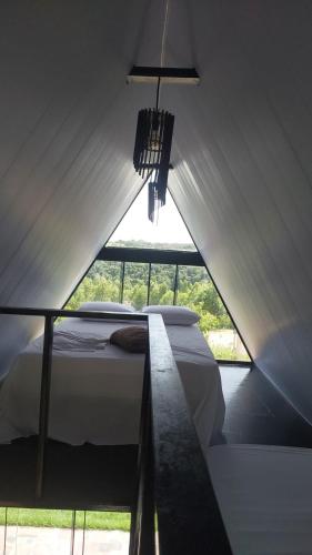 a bedroom with a bed in a tent at Chalé estrela de ouro in Alexânia