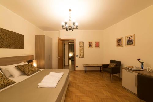 a bedroom with a bed and a chandelier at BBuSS Country Club in Catanzaro