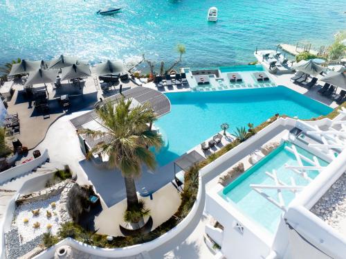 an overhead view of the pool at the beach resort at Kivotos Mykonos - Preferred Hotels & Resorts in Ornos