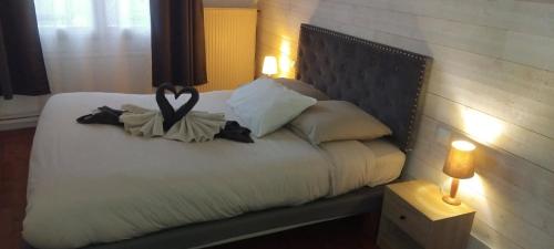 a bedroom with a bed with a heart decoration on it at T2 avec terrasse privative in Le Havre