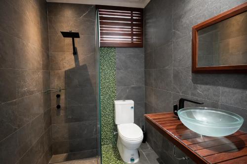 a bathroom with a toilet and a sink at The Original Bel-Air Motel in Port Macquarie