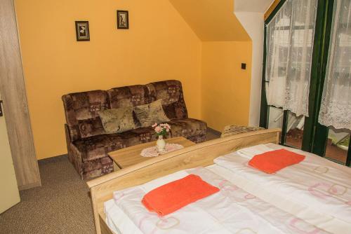 a living room with two beds and a couch at Restaurace a pension První Mlýn Chomutov in Chomutov