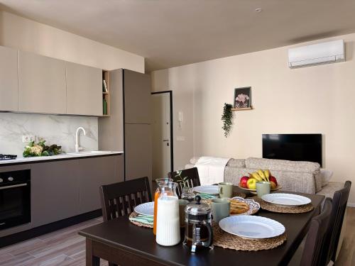 a kitchen and a dining room with a table with food at Tra i gussi in Imperia