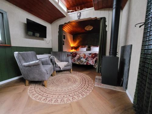 a living room with a room with a bed and a rug at B&B 't Maartensdijkse Bos in Maartensdijk
