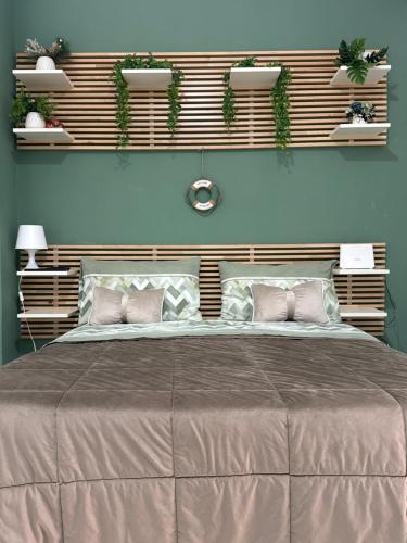 a bedroom with a large bed with two pillows at IL COVO DEL PESCATORE in Pozzuoli