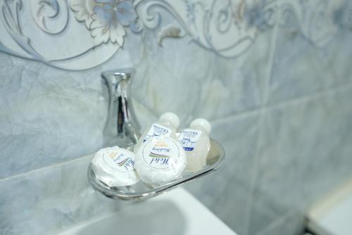 a glass holder on a sink in a bathroom at Rasulboy Guest House in Khiva