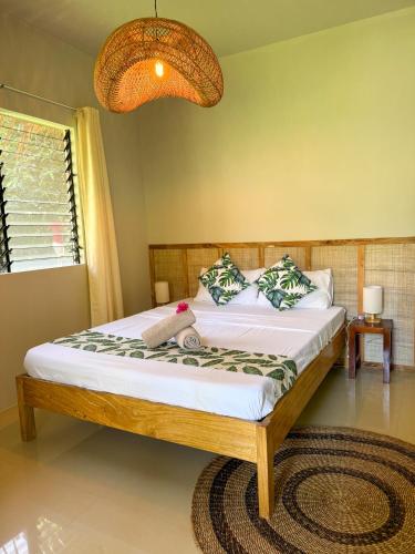 a bedroom with a bed with a stuffed animal on it at Happy Coconut Camiguin in Mambajao