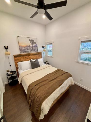 a bedroom with a large bed with a ceiling fan at The Ultimate View - Private Spa & Fireplace in Temecula