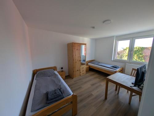 a bedroom with a bed and a couch and a table at Ferienwohnung Gästehaus Bauer 1 in Heiligenhaus