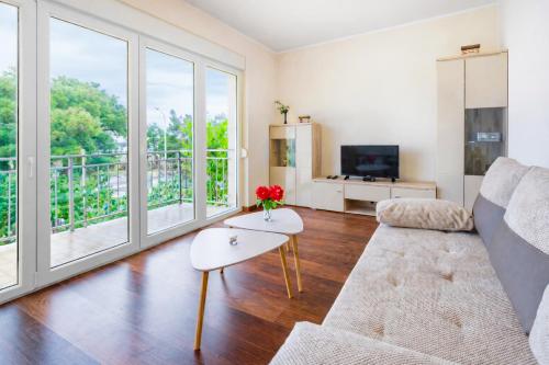 a living room with a couch and a table at Apartment Patrik by Rent Istria in Umag