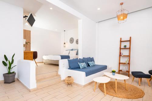 a living room with a couch and a bed at Evnia apartments in Vóthon