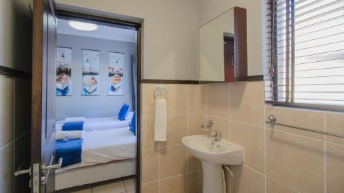 a bathroom with a sink and a mirror at 7 Topanga in Uvongo Beach