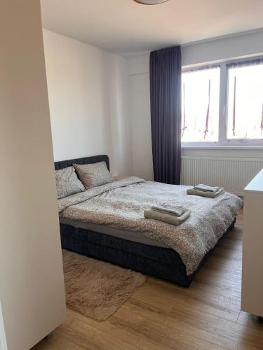 a bedroom with a bed with two towels on it at Confort Suite in Alba Iulia