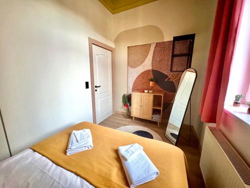 a bedroom with a bed with two towels on it at Buda's Hidden Heaven 1 with Private Sauna in Budapest