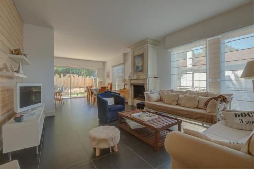 a living room with a couch and a table at Maison des Abatilles- Bassin Arcachon in Arcachon