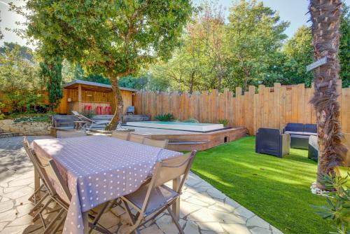 a backyard with a table and chairs and a fence at Maison des Abatilles- Bassin Arcachon in Arcachon