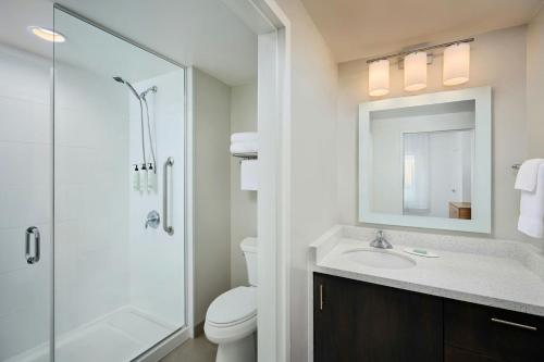 a bathroom with a toilet and a sink and a shower at TownePlace Suites by Marriott Ottawa Kanata in Ottawa
