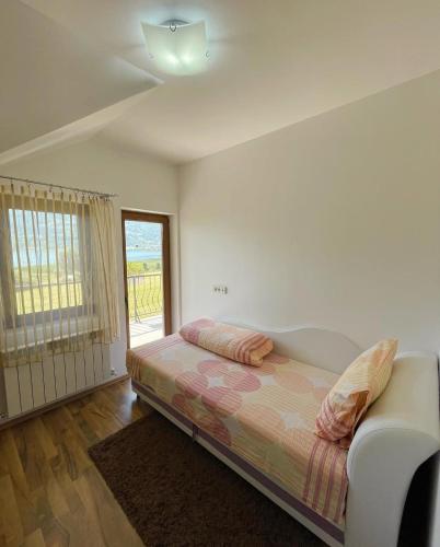a bedroom with a bed and a window at Guest House Blue Views in Plav