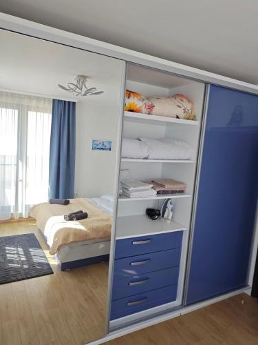 a bedroom with a closet with a bed in it at Trend Apart in Burgas